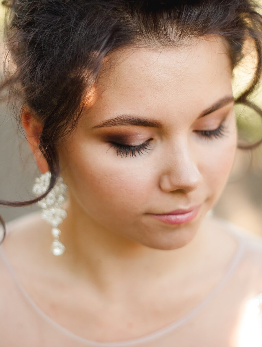 Photo by Kateryna Hliznitsova woman in white shirt with silver necklace